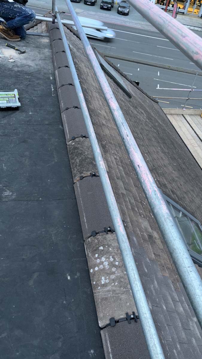 Completed dry-ridge installation on a tiled roof after repair