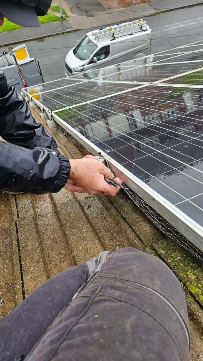 Fitting wire mesh bird proofing under domestic solar panels